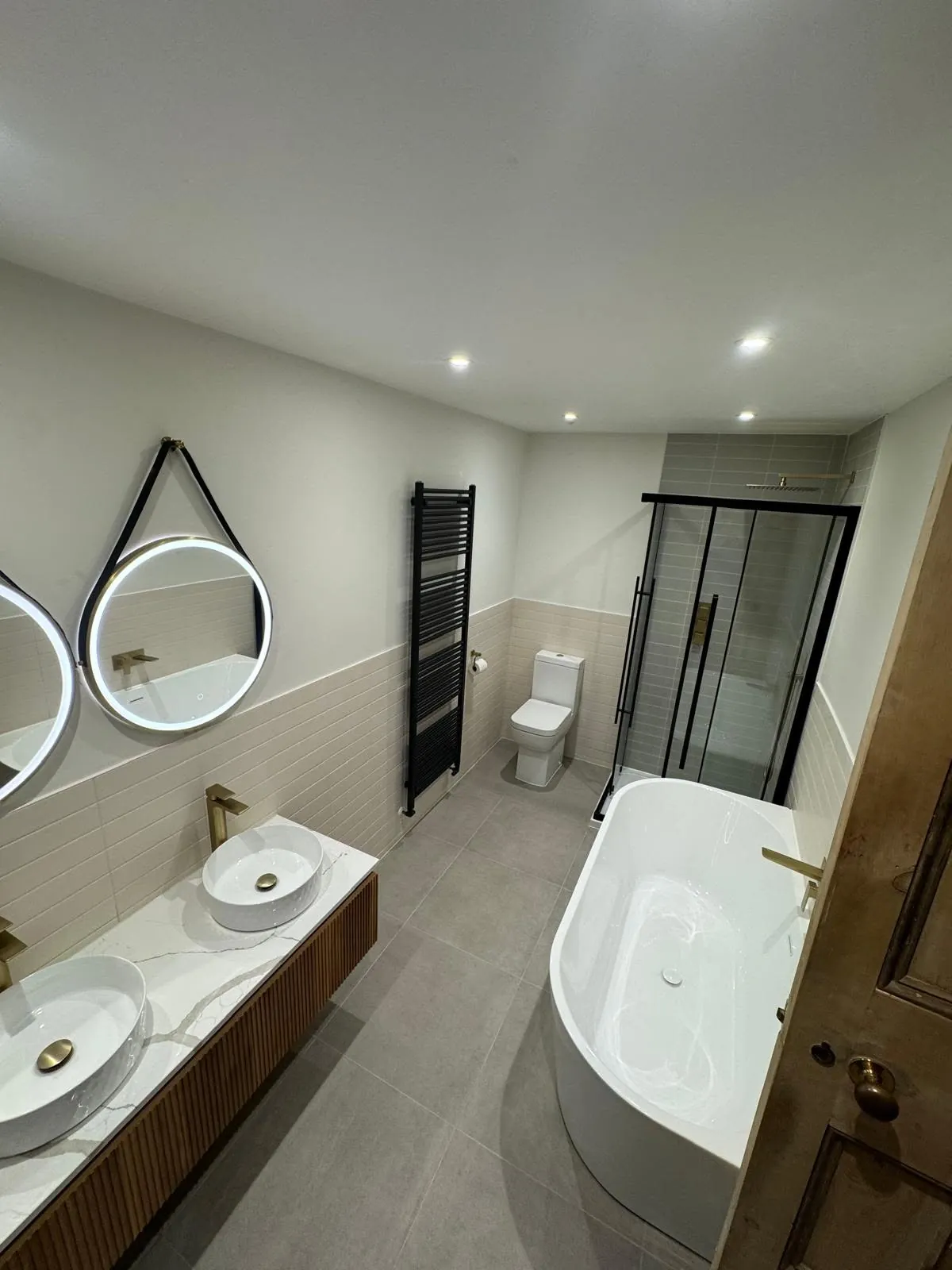 Bathroom installation by Space B Tiling: spacious bathroom with freestanding bath and double vanity