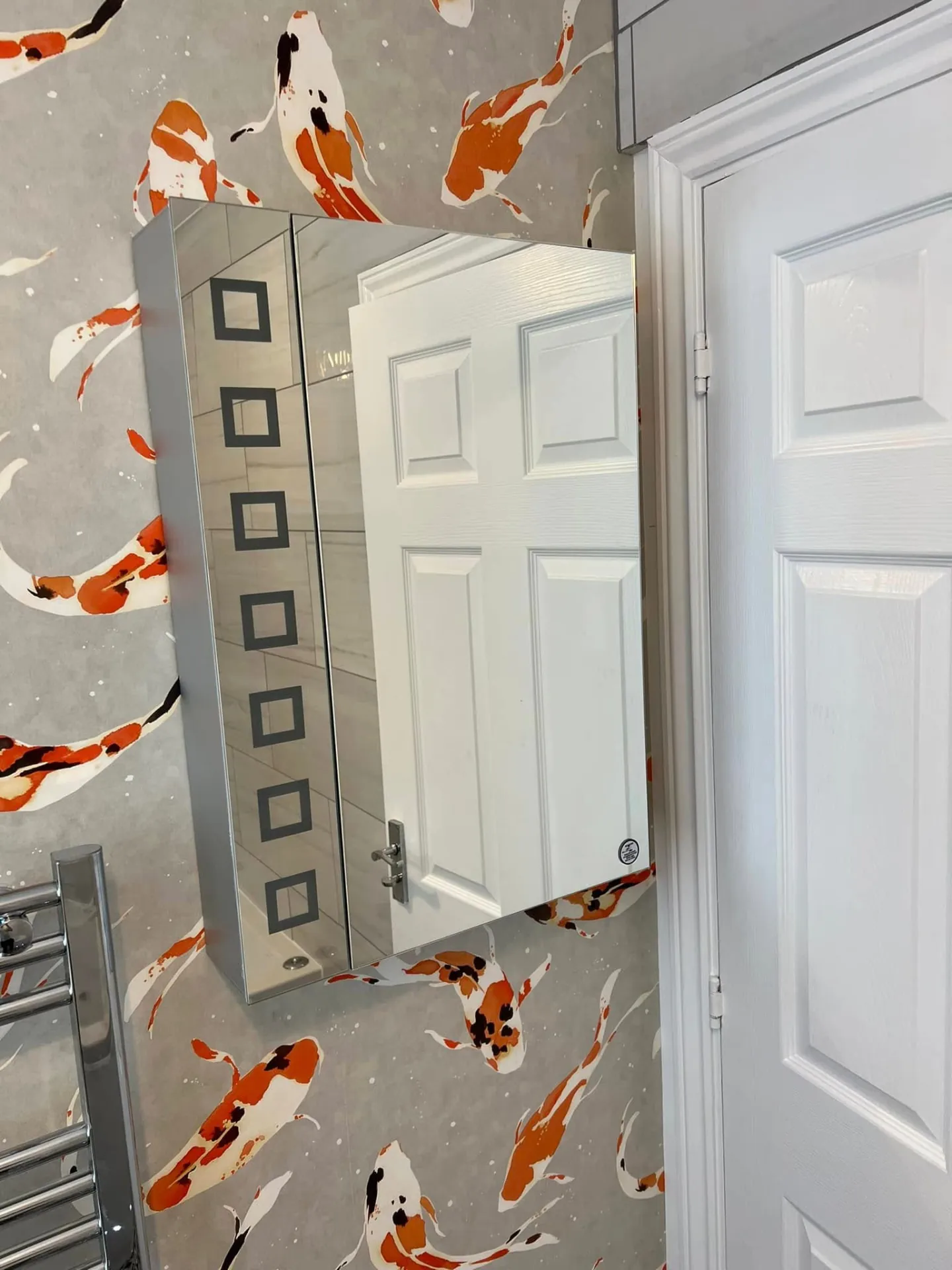 Decorating by Space B Tiling: koi feature wallpaper with mirror cabinet