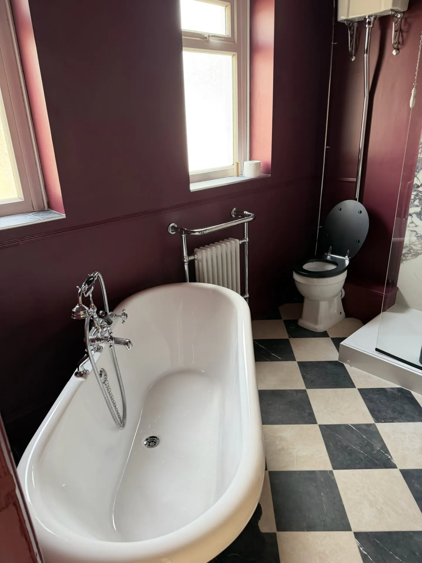 Bathroom installation by Space B Tiling: freestanding bath, chrome radiator and chequered floor