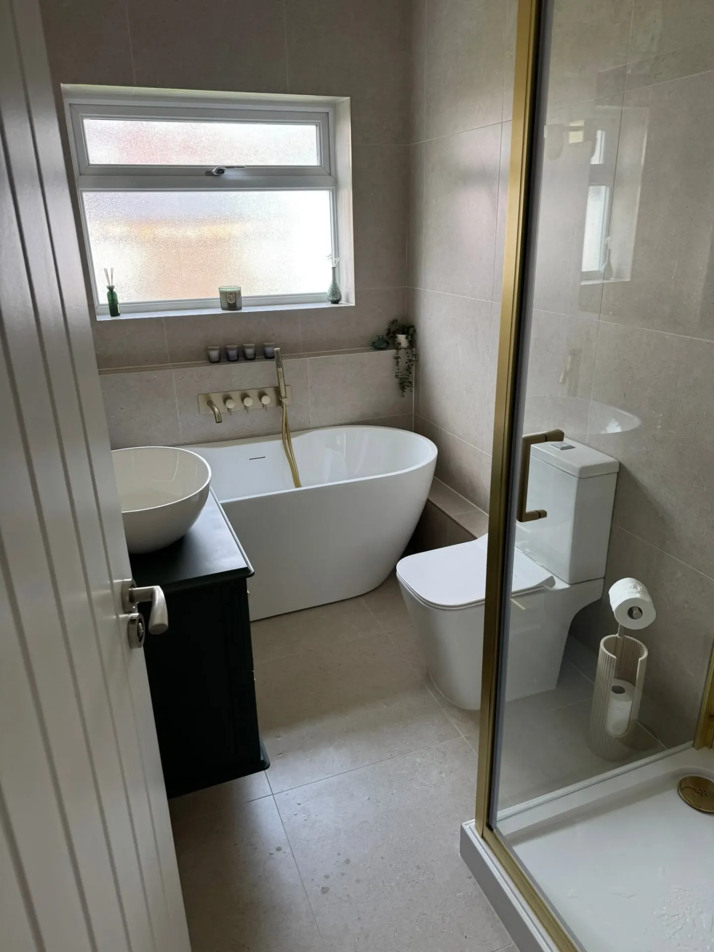 Bathroom installation by Space B Tiling: freestanding bath and brass-framed shower enclosure