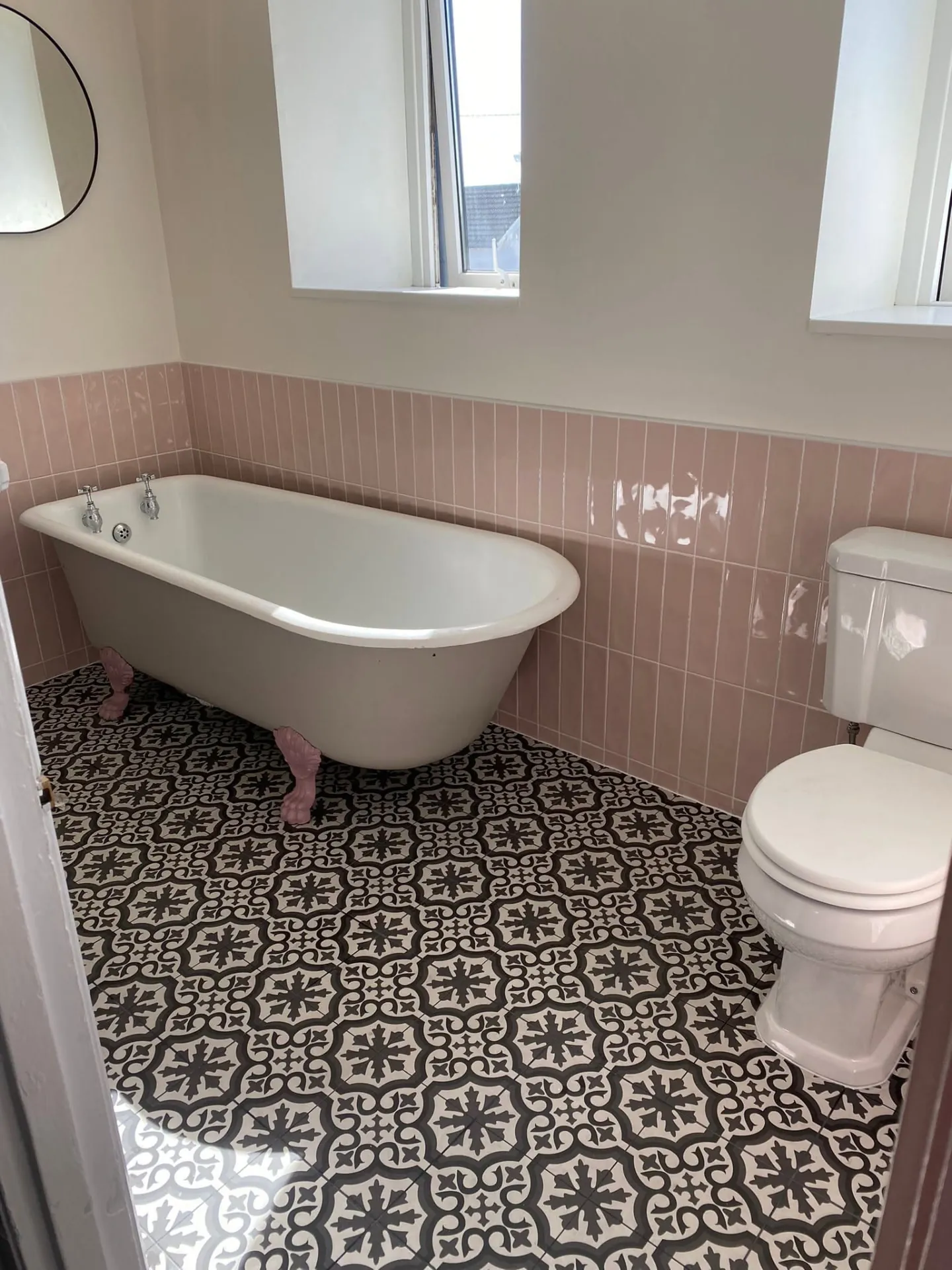 Bathroom installation by Space B Tiling: claw-foot bath with pink tiles and patterned floor