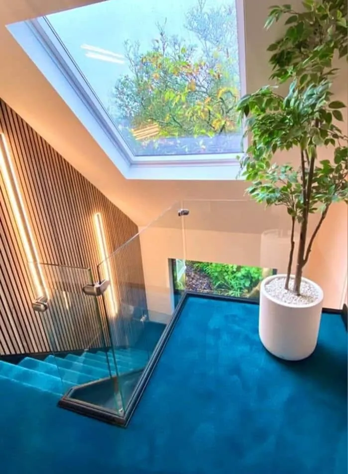Interior renovation by Space B Tiling: glass balustrade landing with slatted timber wall panelling