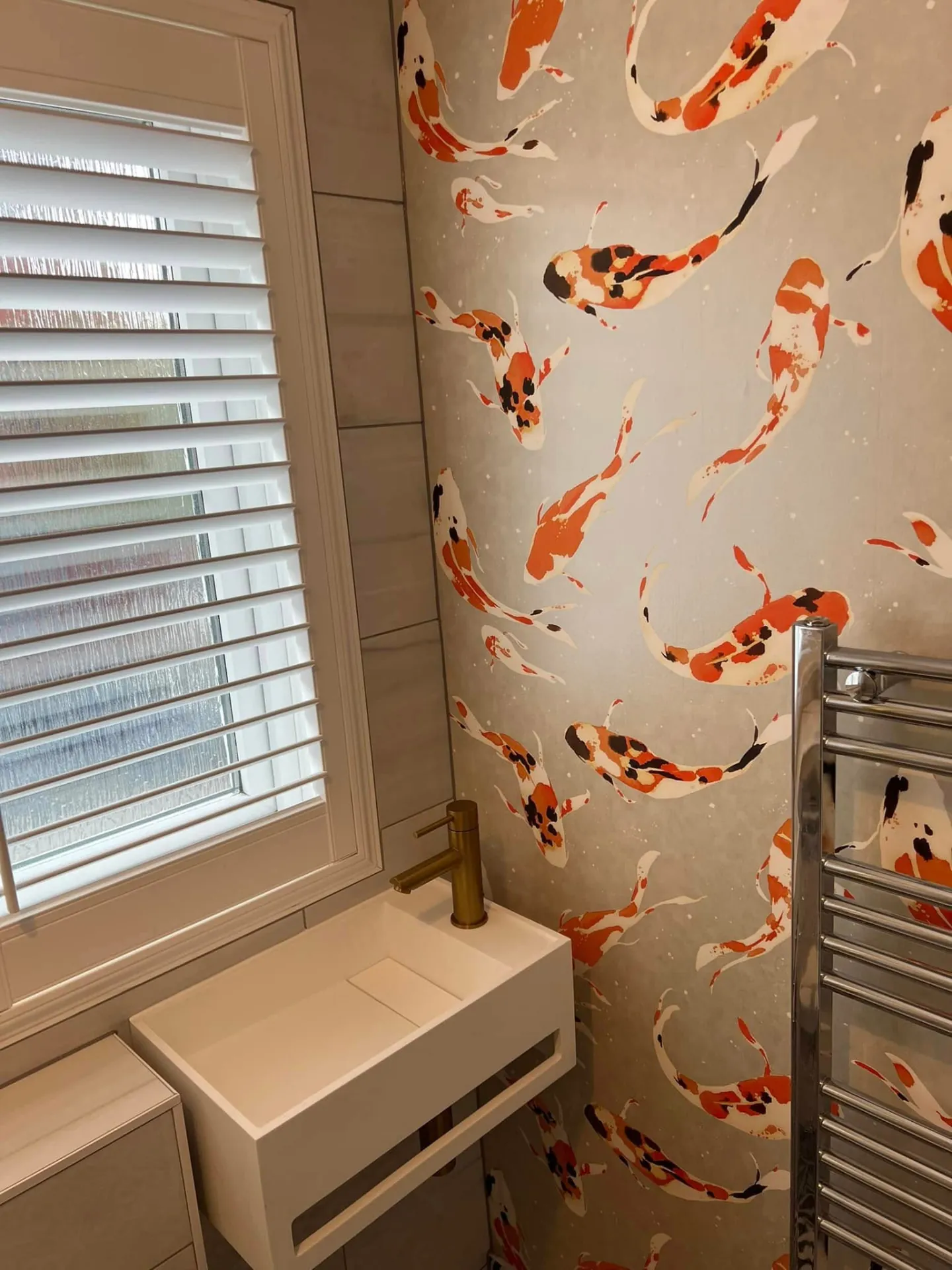 Decorating by Space B Tiling: koi feature wallpaper beside basin