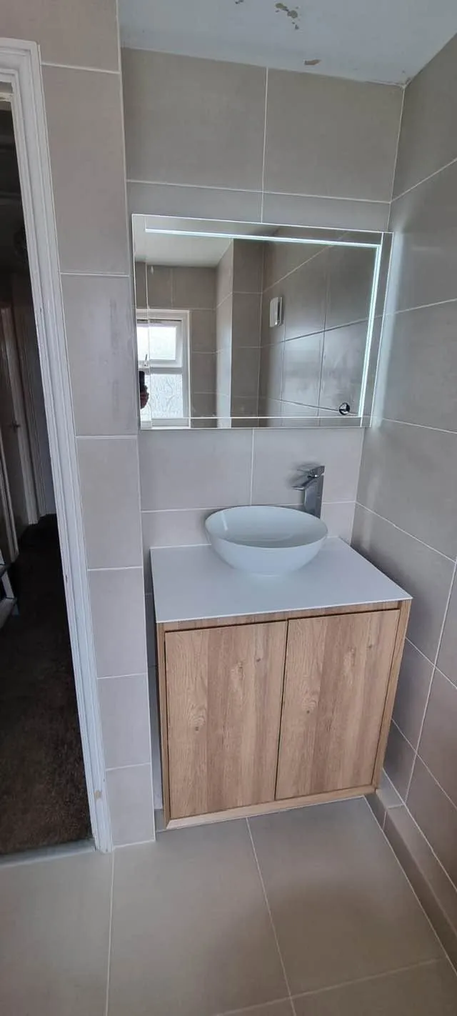 Bathroom installation by Space B Tiling: vanity with countertop basin and mirror