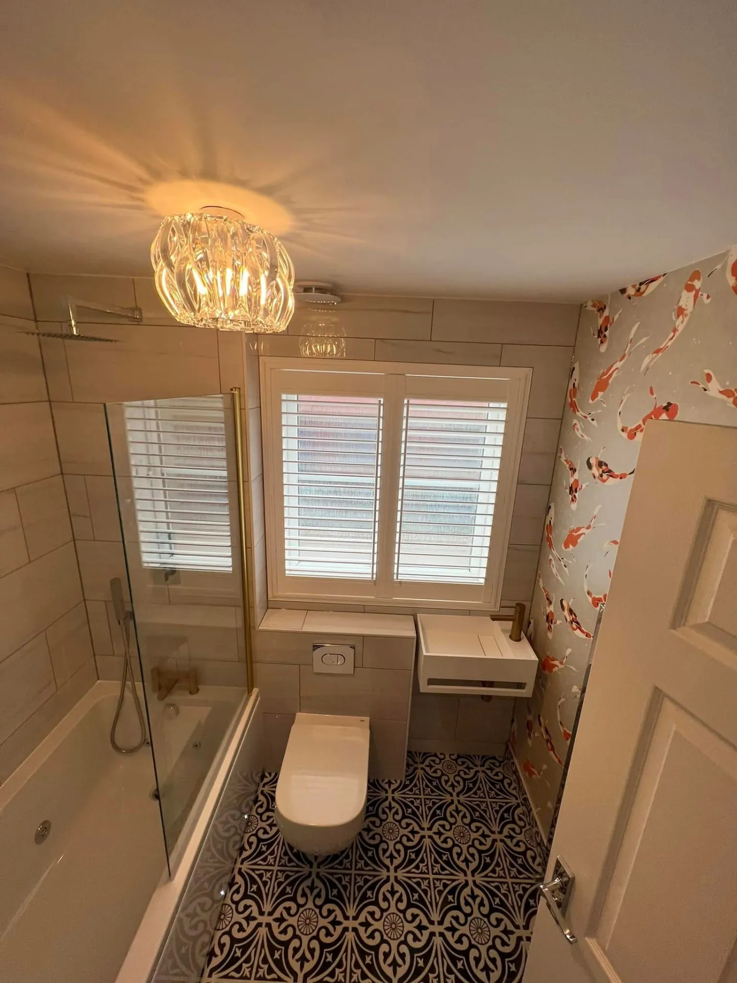 Bathroom installation by Space B Tiling: compact bathroom with shower and patterned floor tiles