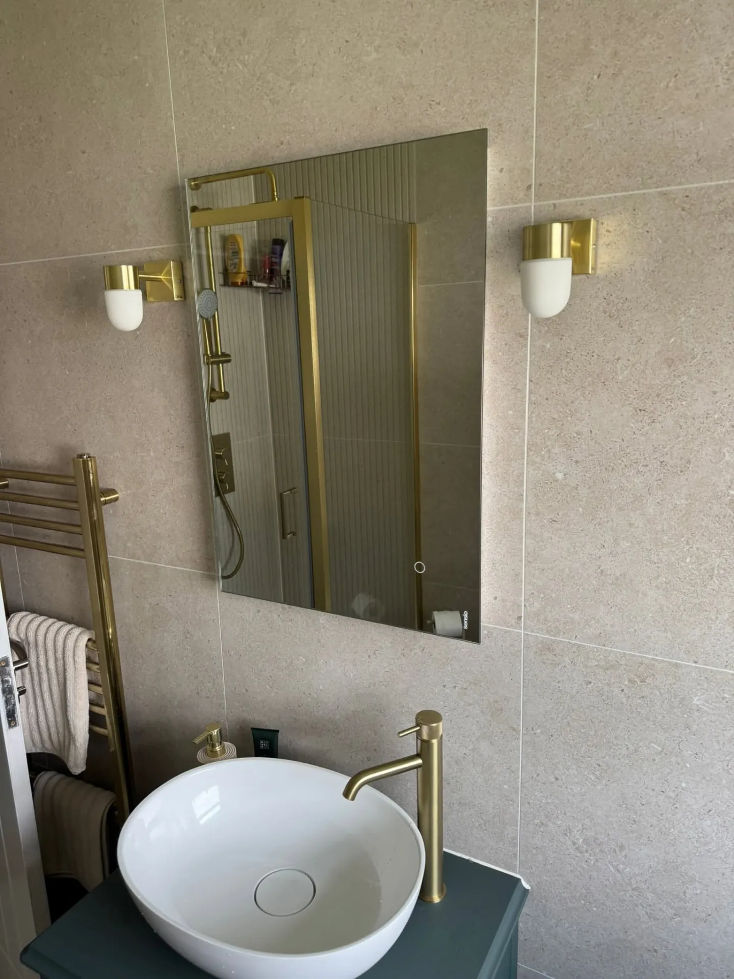 Bathroom installation by Space B Tiling: countertop basin, brass tap and wall lights