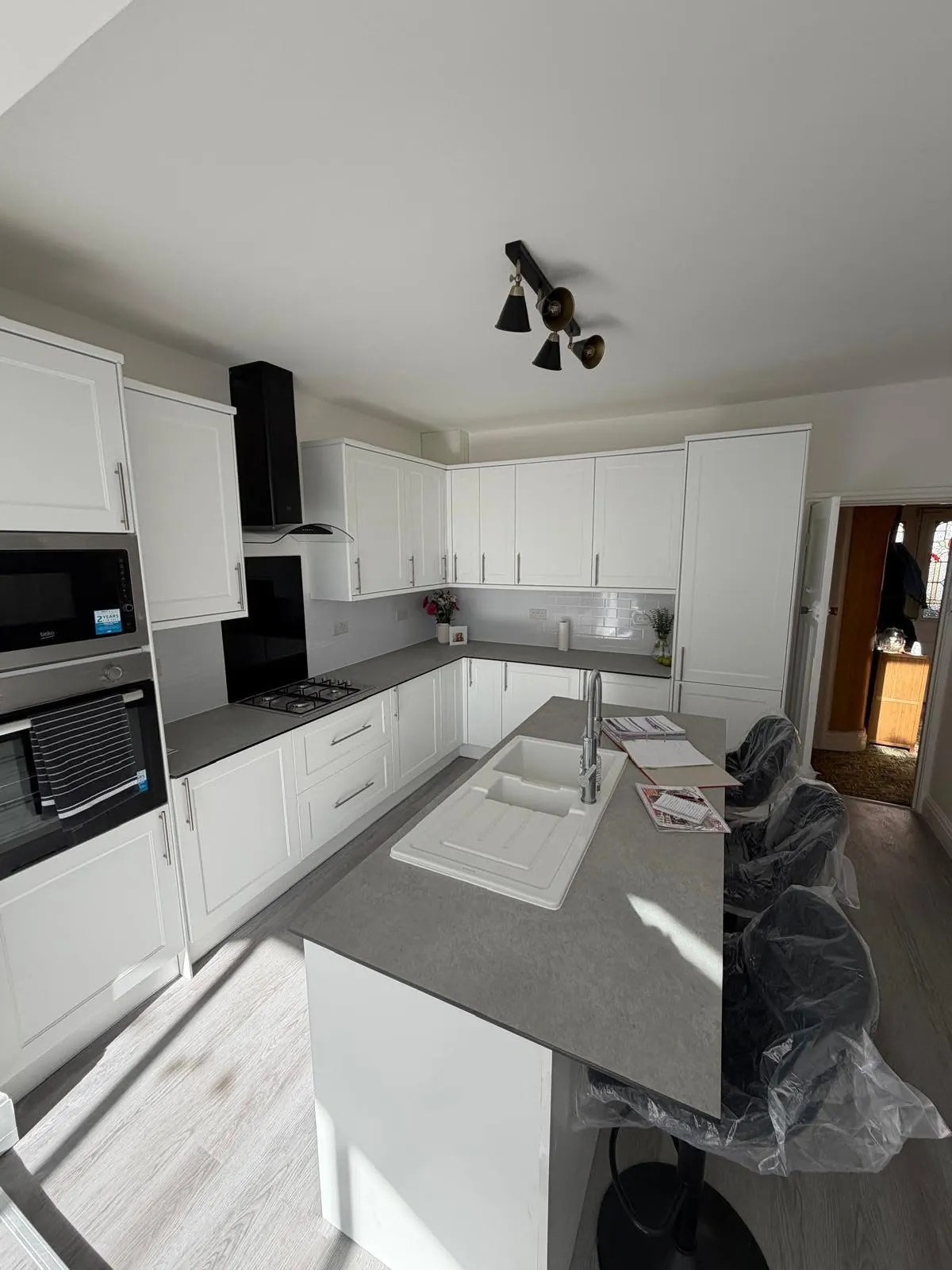 Kitchen installation by Space B Tiling: white shaker kitchen with island and inset sink