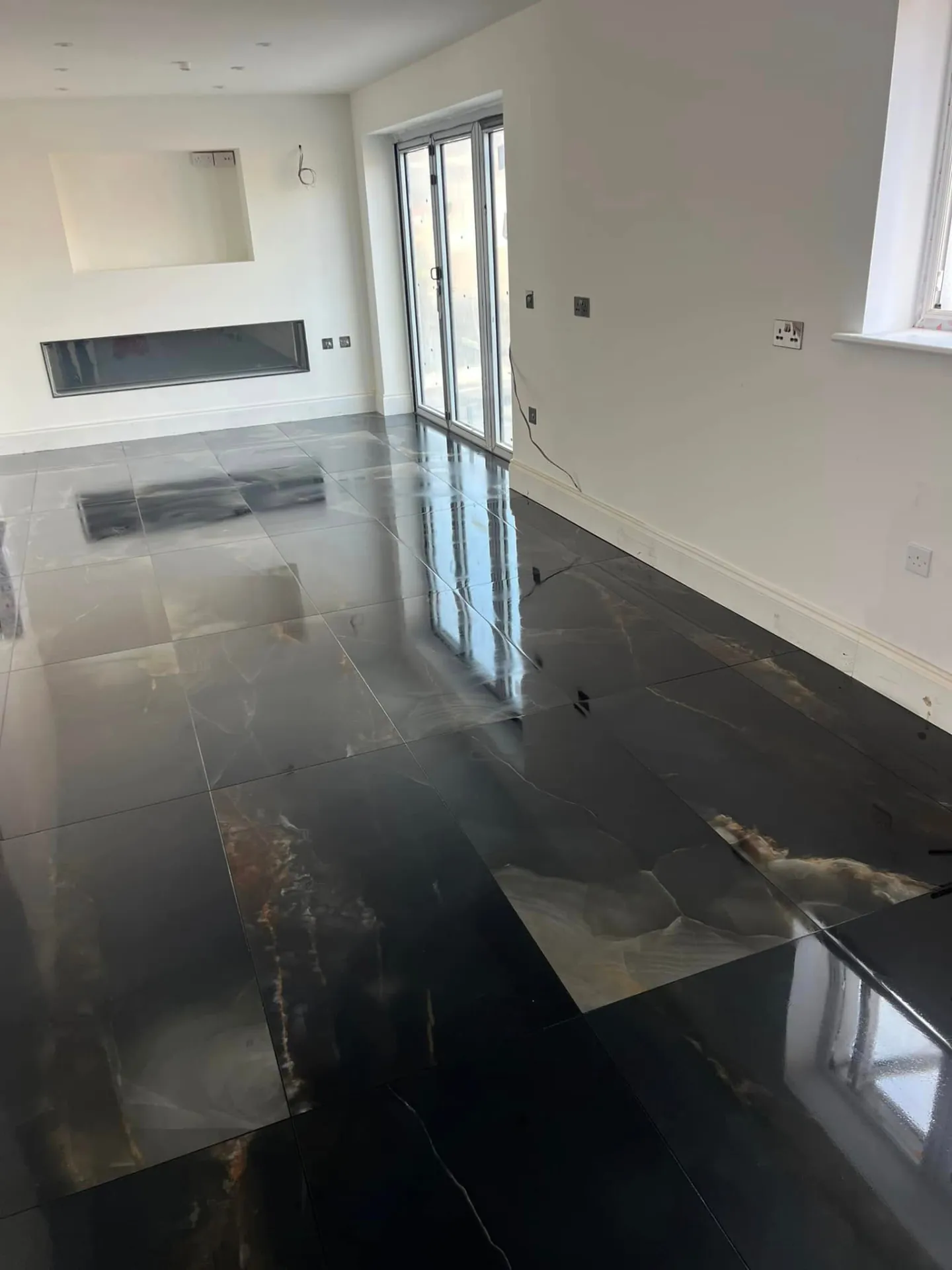 Floor tiling by Space B Tiling: large-format black marble-effect floor tiles