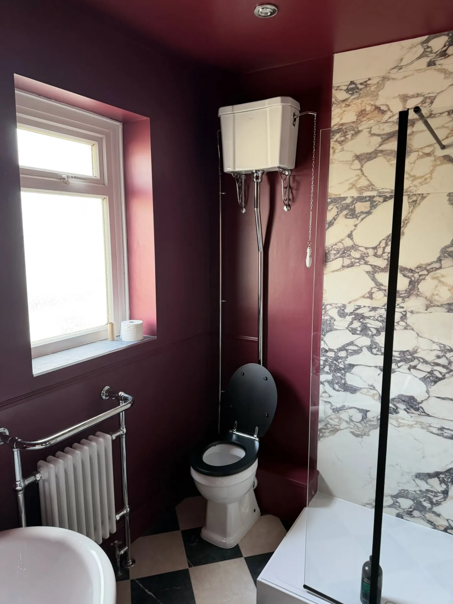Bathroom installation by Space B Tiling: high-level cistern toilet, burgundy walls and chequered floor