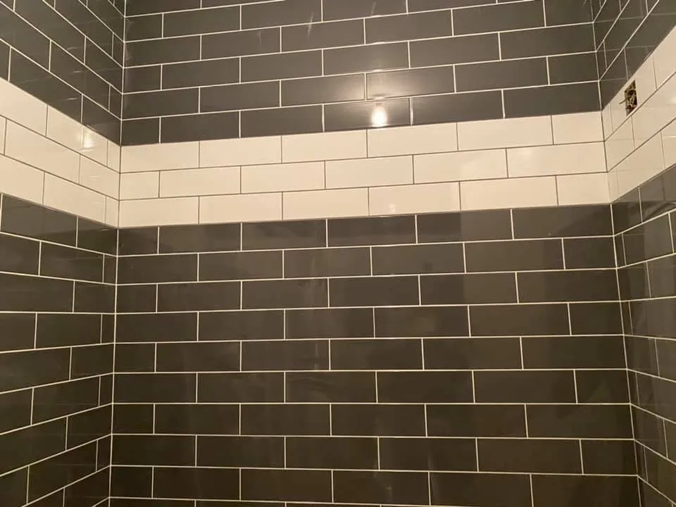 Wall tiling by Space B Tiling: grey metro tiles with white band