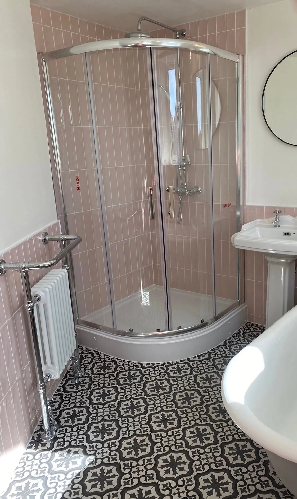 Bathroom installation by Space B Tiling: quadrant shower with pink tiles and patterned floor