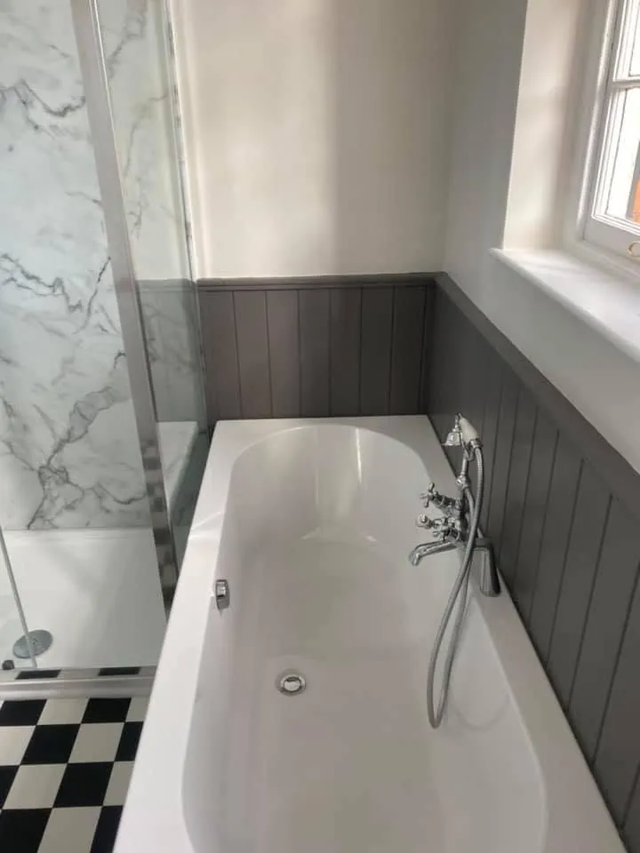 Bathroom installation by Space B Tiling: bath beside a marble-effect shower enclosure