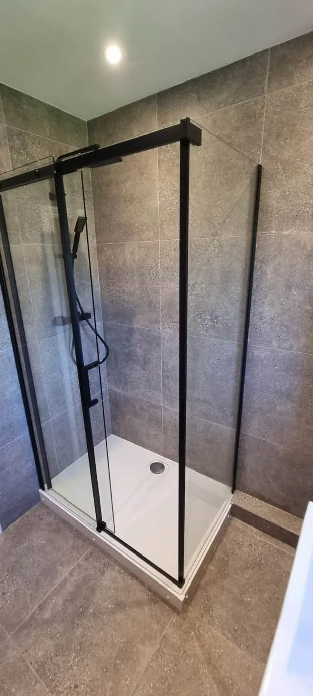Bathroom installation by Space B Tiling: black-framed shower enclosure with stone-effect tiles